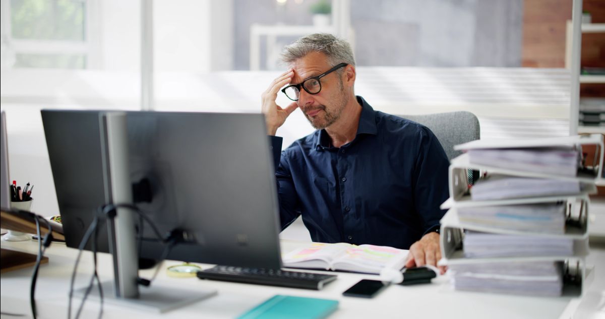 Man in front of computer frustrated