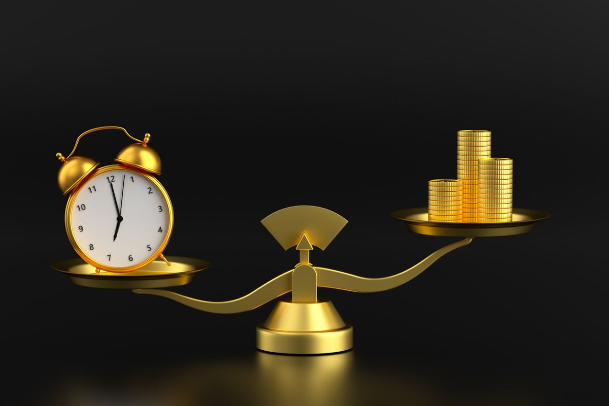 Photo of scale weighing time against money