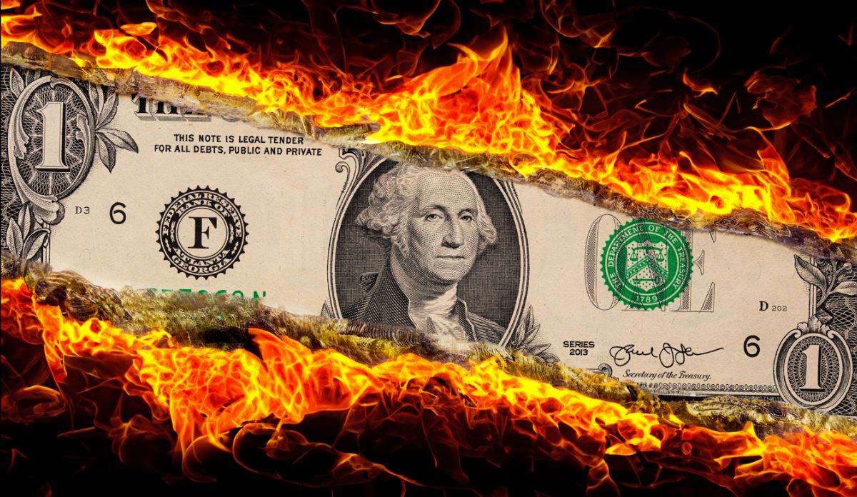 Photo of money catching on fire