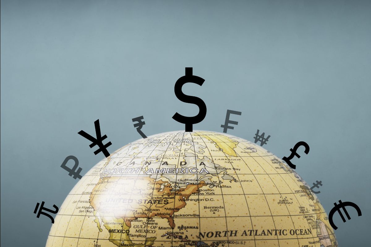 Globe with international currency symbols including the U.S. dollar illustrating the dollar’s central role in the global financial system.