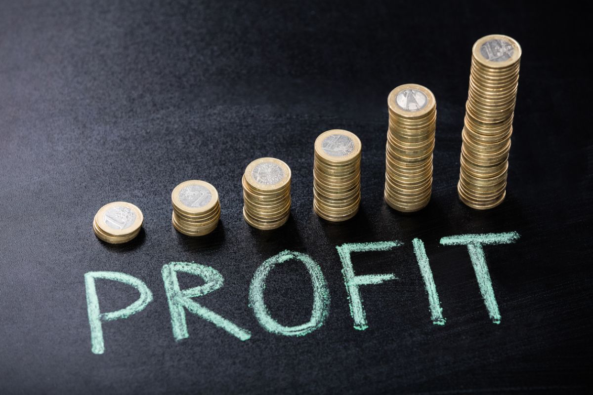 Stacks of coins arranged in ascending order with the word “profit” written in chalk illustrating investment gains and the importance of taking profits during volatile market conditions.