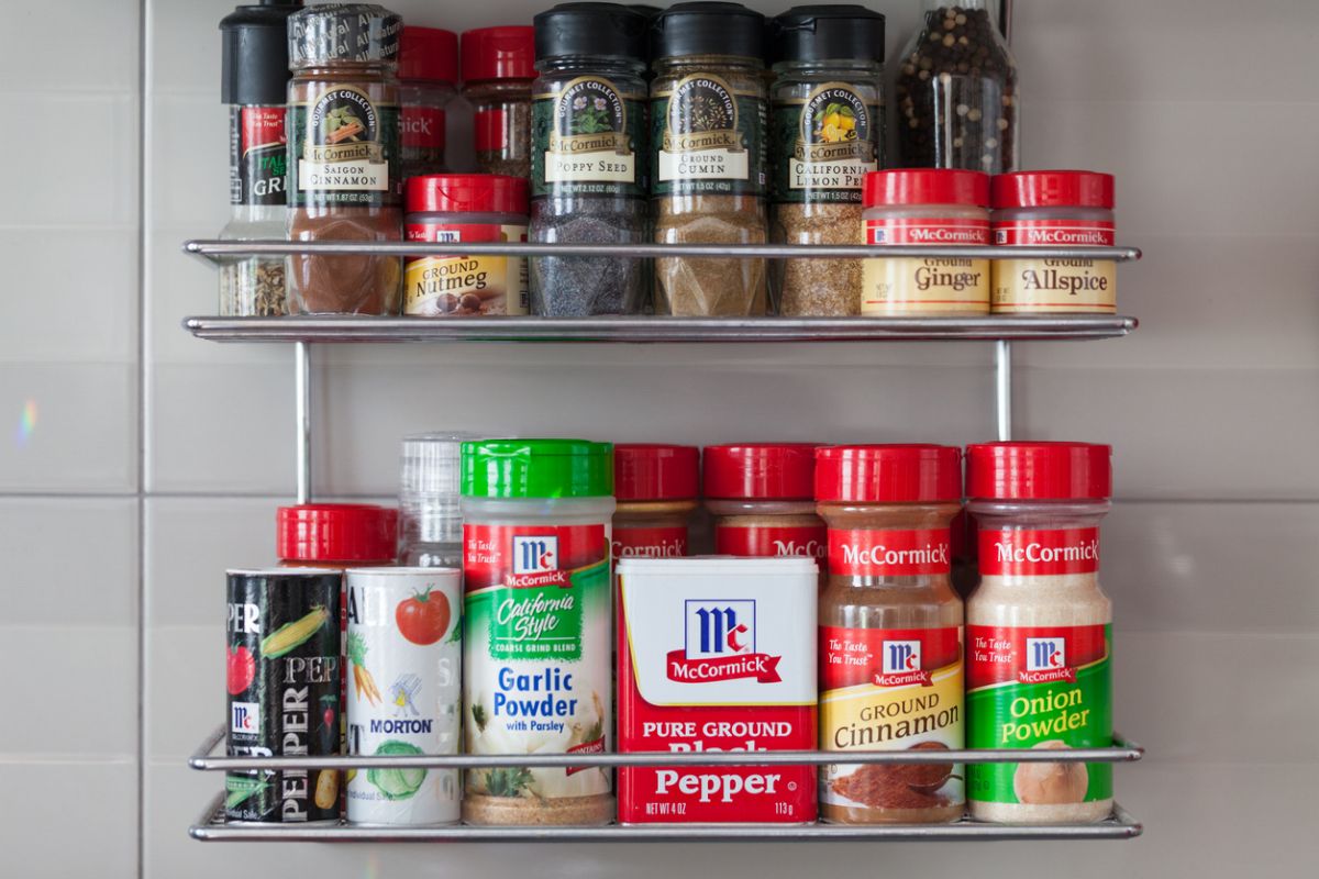 McCormick spices and seasonings arranged on a kitchen shelf, representing the consumer staples sector and defensive companies with stable demand during volatile market conditions.