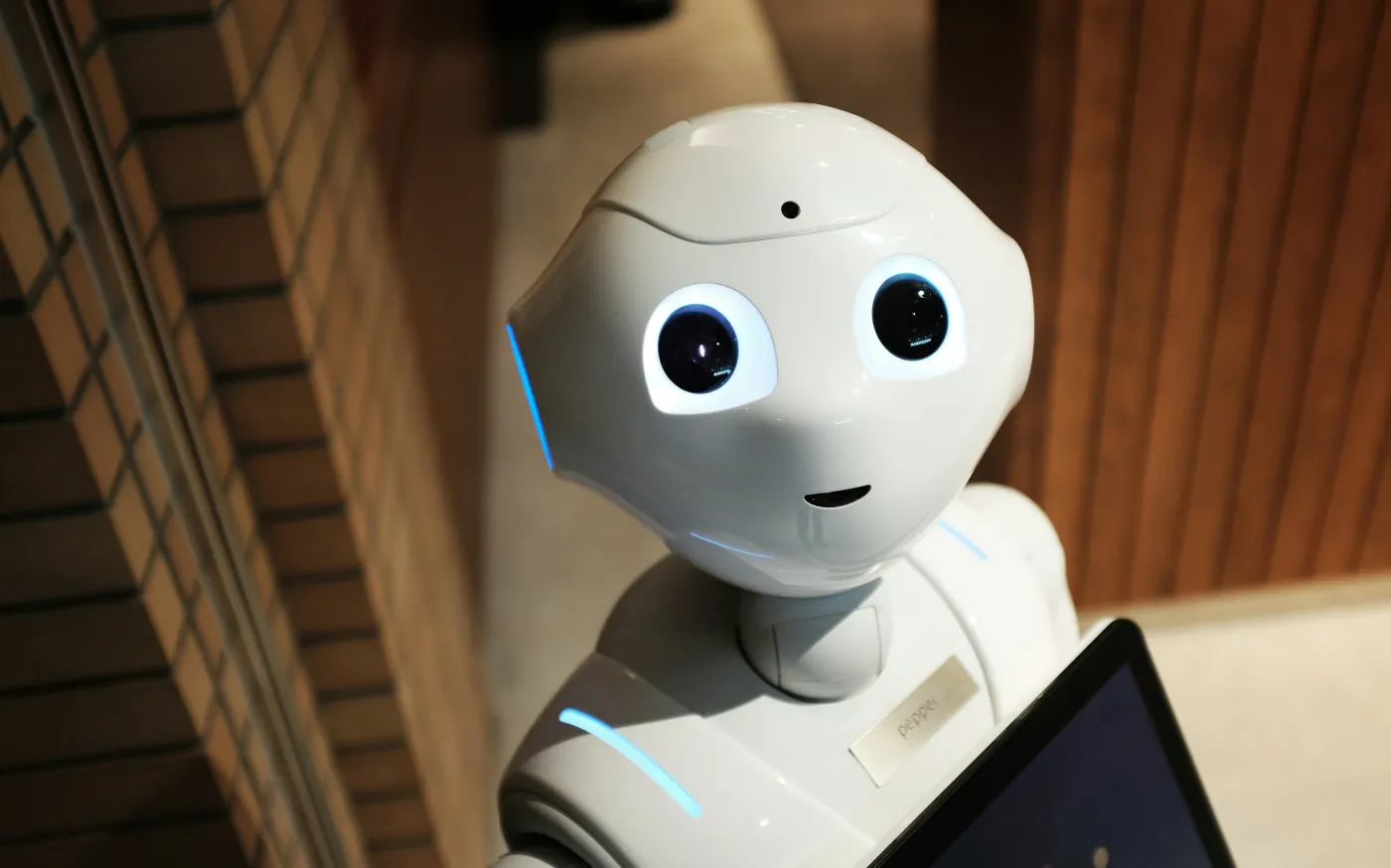 white robot near brown wall by Alex Knight courtesy of Unsplash.