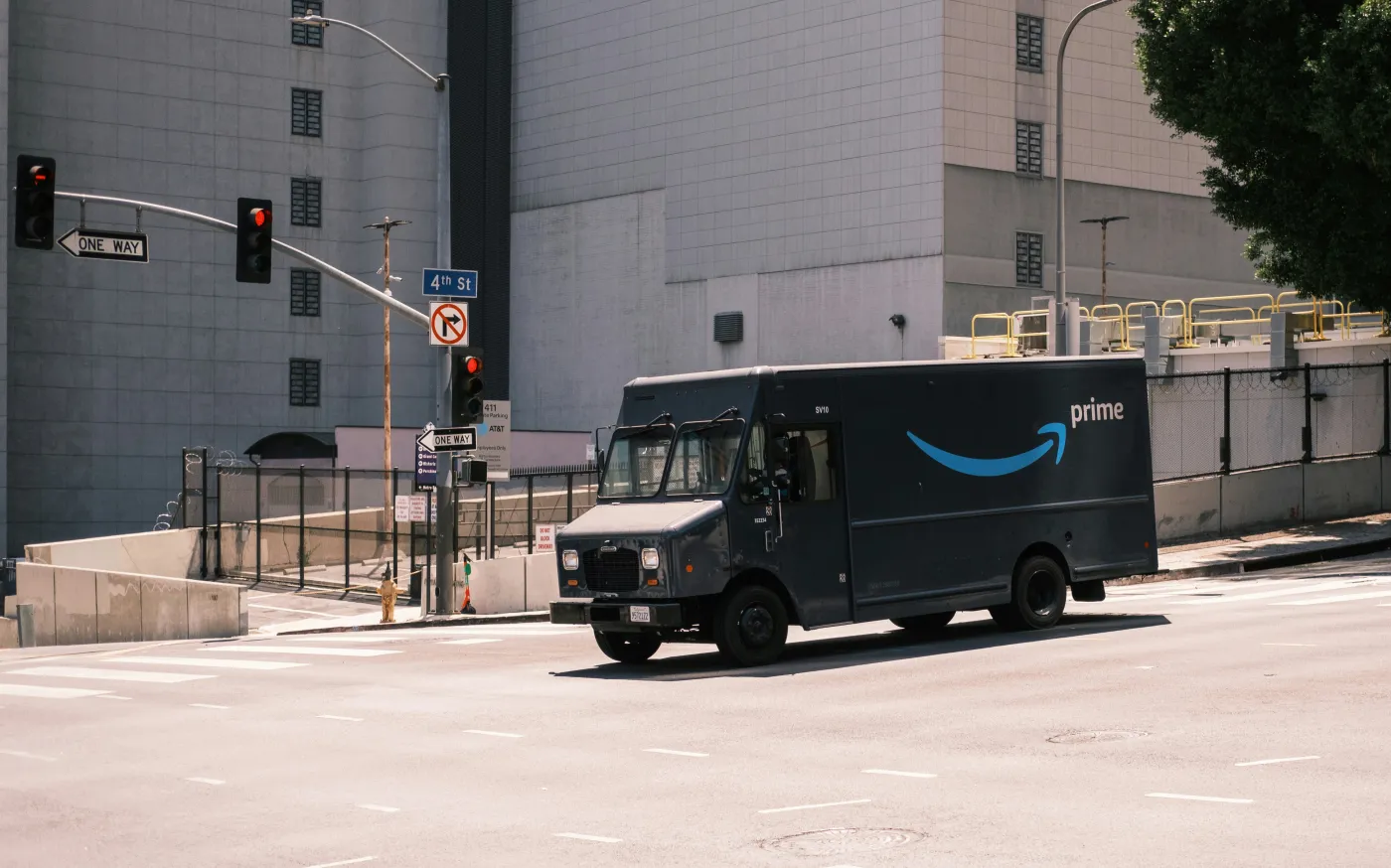 blue and white van parked near white building during daytime by Andrew Stickelman courtesy of Unsplash.
