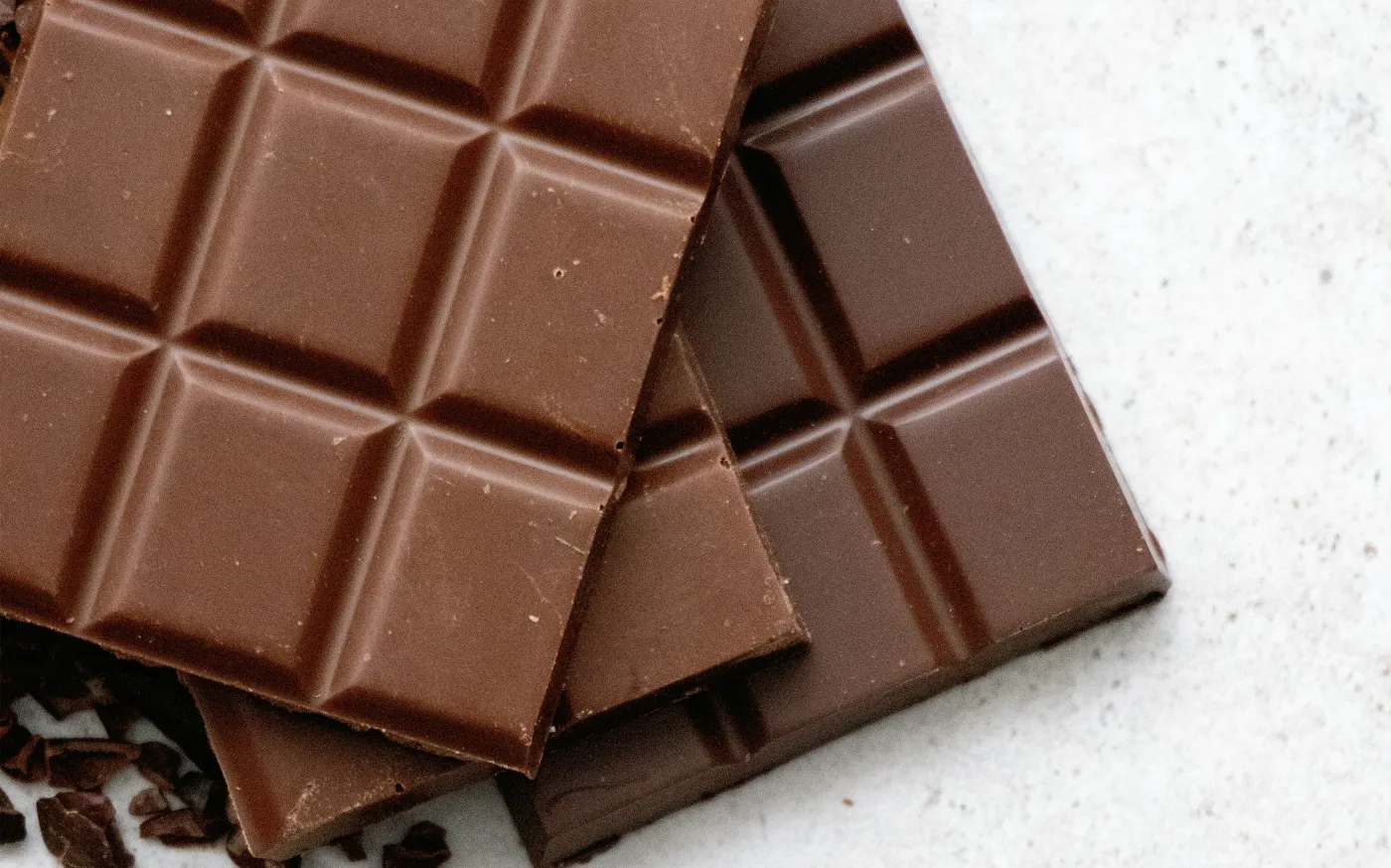 chocolate bar on white table by Tetiana Bykovets courtesy of Unsplash.