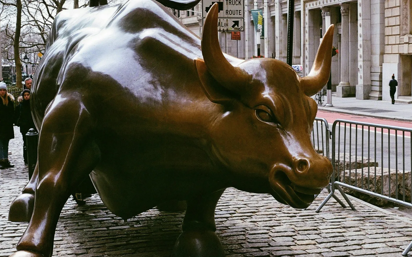 A statue of a bull on a city street by osamu nakazawa courtesy of Unsplash.