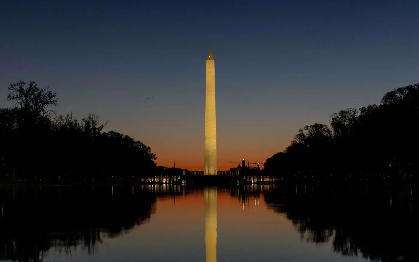 the washington monument is reflected in the water by Harrison Mitchell courtesy of Unsplash.