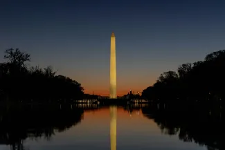 the washington monument is reflected in the water by Harrison Mitchell courtesy of Unsplash.